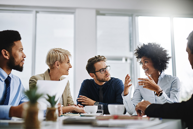 Shot of a group of business people sitting together in a meeting