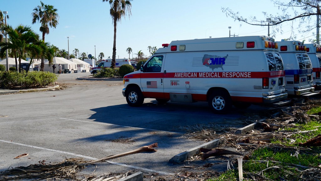 Amubulances on standby in a parking lot