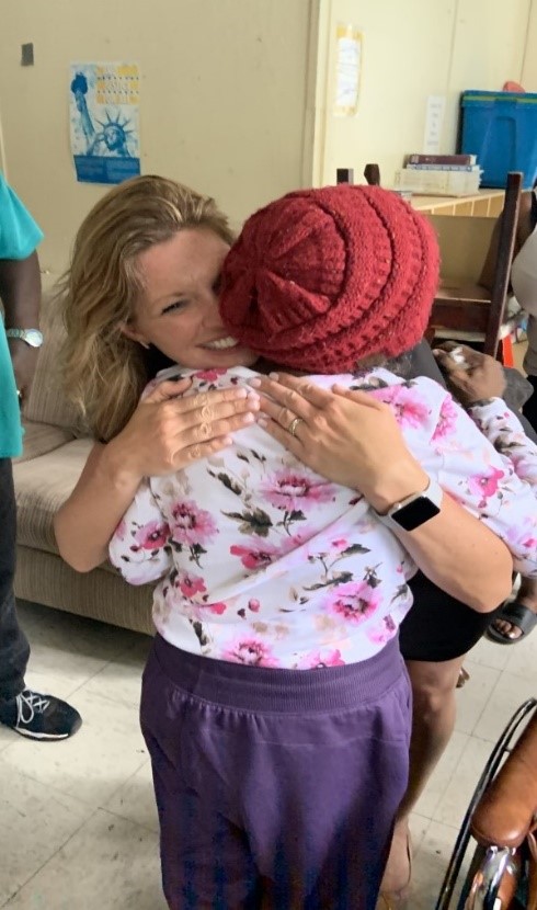 NDMS personnel hugging an elderly patient.