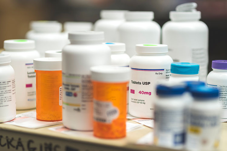 a line of various bottles of prescription medicine