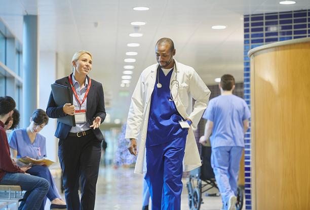 Healthcare executive in a conversation with a male and female medical staff